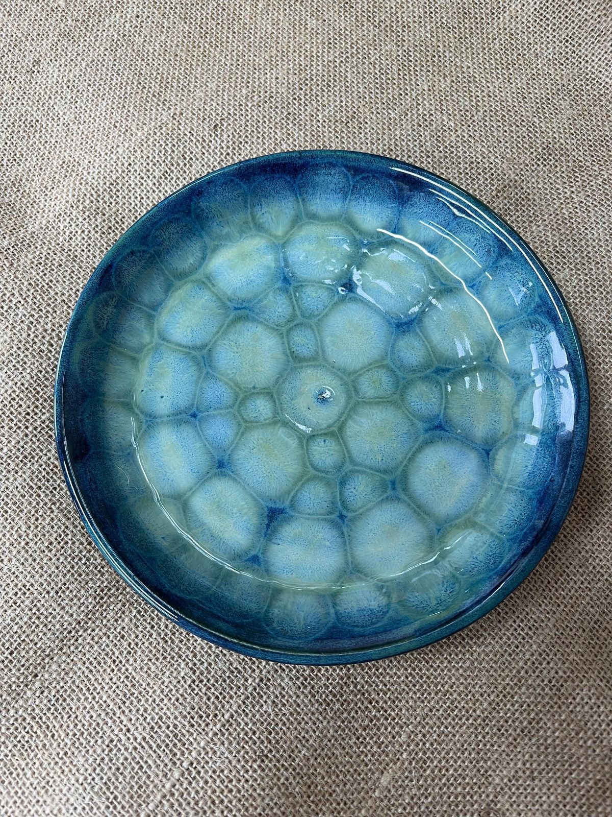 Dipping a ceramic piece into glossy glaze