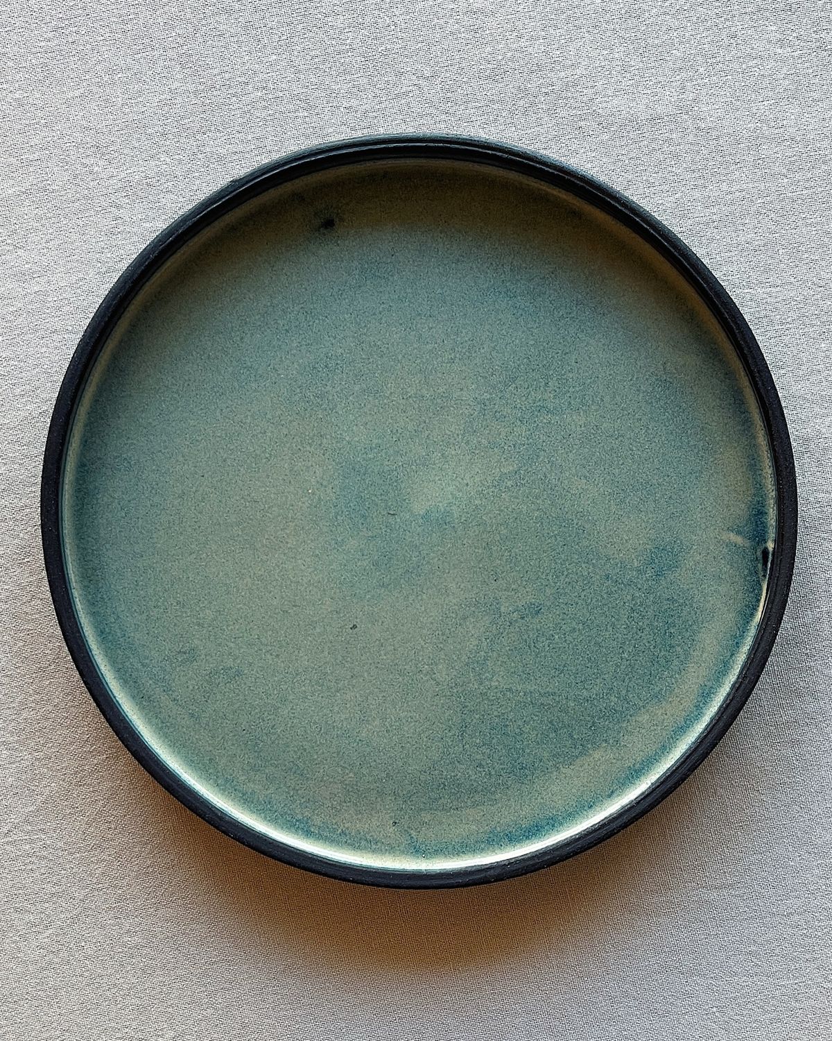 Brushing matte glaze onto a ceramic piece